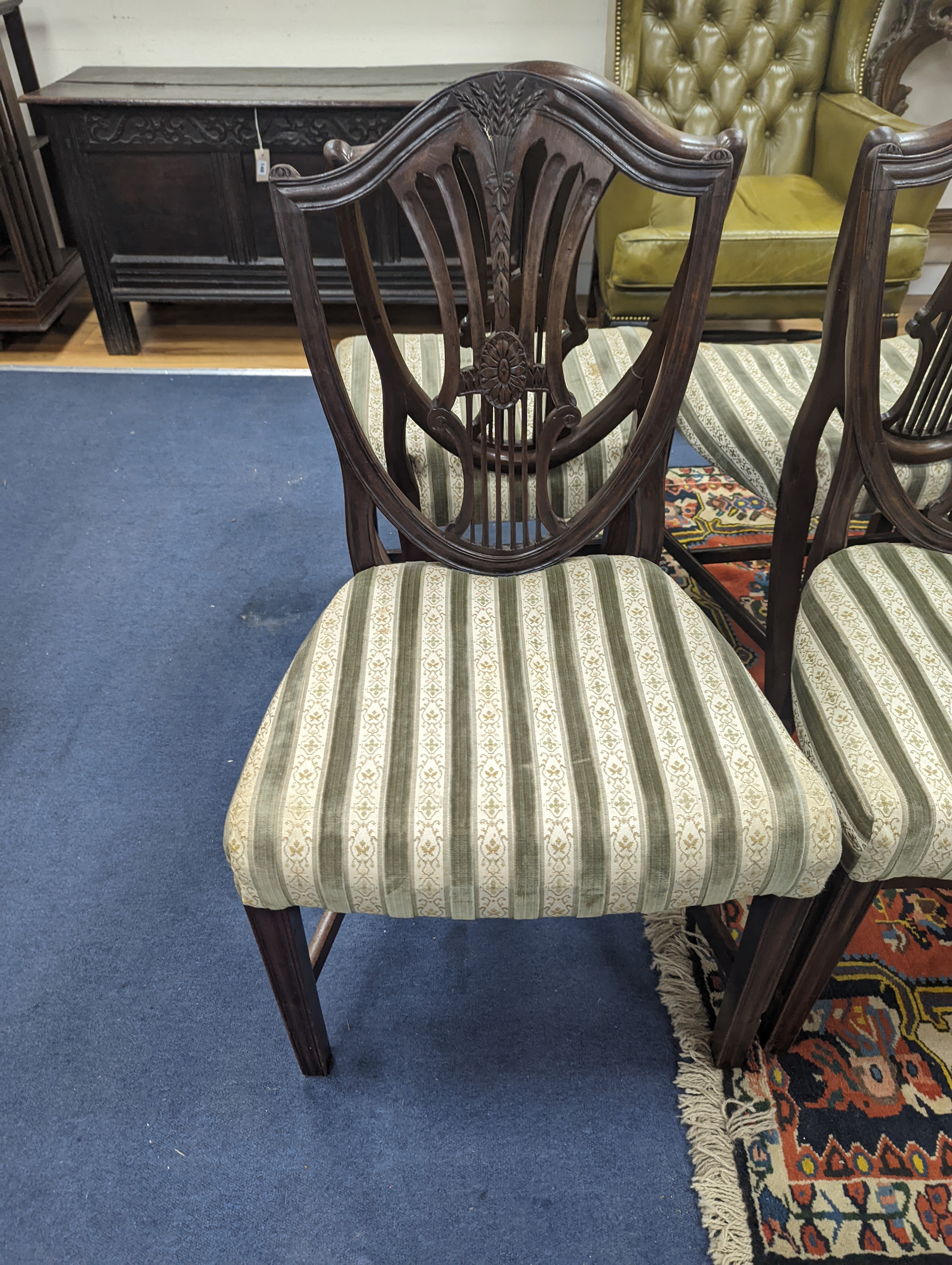 A set of six Sheraton style mahogany dining chairs with shield backs on square tapered legs